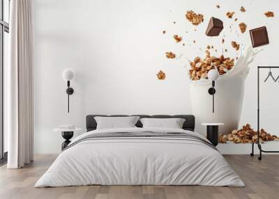 A white cup with cereal and chocolate chips in it is on a white background Wall mural