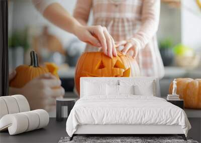 A woman and a child are carving a pumpkin together Wall mural