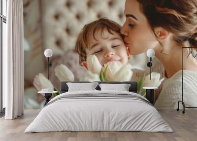 A woman is kissing a child on the cheek while holding a bouquet of white flowers. Happy Mother's Day concept Wall mural