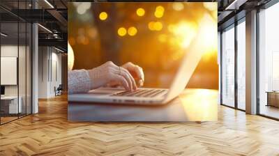 A woman is typing on a laptop computer Wall mural