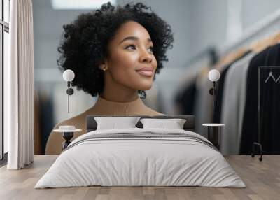 A woman with curly hair is smiling at the camera in a store Wall mural