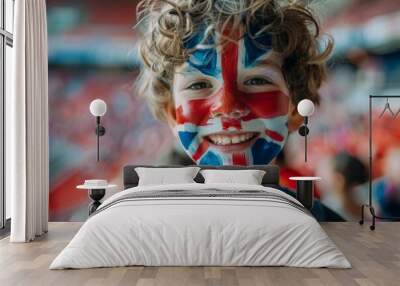 A young boy with a British flag painted on his face is smiling. Football fans at the football championship Wall mural