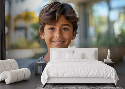 A young boy with brown hair and a grey shirt is smiling Wall mural