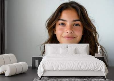 A young woman with brown hair and a white shirt is smiling Wall mural