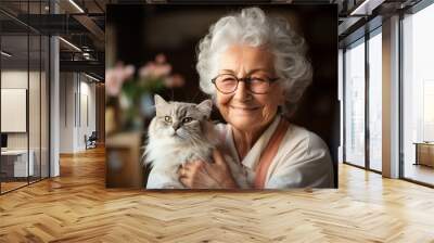 An aged woman hugs her beloved cat. Portrait with selective focus and copy space Wall mural