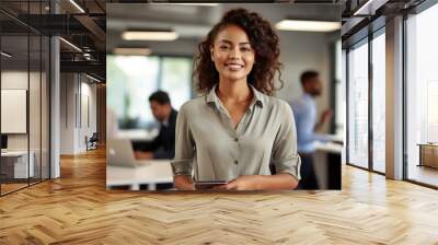 Happy and cheerful woman executive in a corporate office. Portrait with selective focus and copy space Wall mural