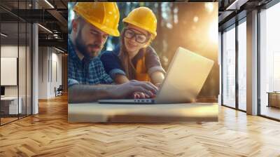 Two people are looking at a laptop together Wall mural