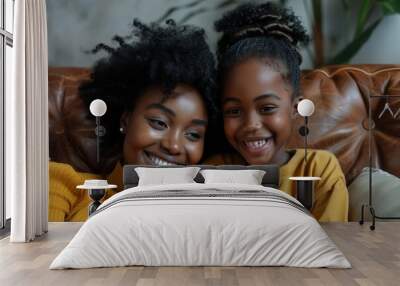 Two women are sitting on a couch, one of them holding a cell phone Wall mural