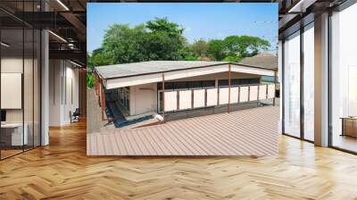 second floor house building with pattern tiles roof. brown metal sheet roofs. Wall mural