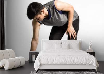 Portrait of an asian sport man stretching his bodies before exercise. Isolated full length on white background with copy space and clipping path Wall mural