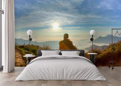 Monk sitdown on the rock with sunset. Wall mural