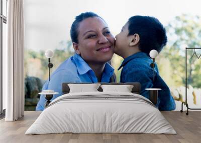 Latino boy giving his mother a kiss Wall mural