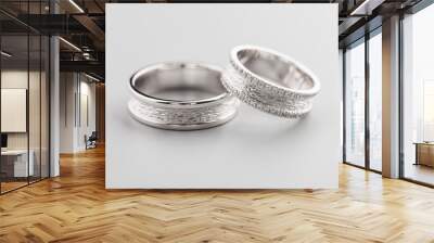 Two silver wedding rings with diamonds on gray background Wall mural