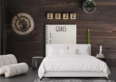 2022 goals text on notepad with coffee cup and pen on wooden desk Wall mural