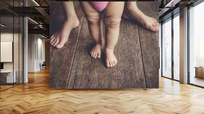 happy baby learning to walk with mother help Wall mural