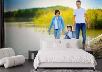 happy family walks on the nature near the lake, go for a ride on the water and splash Wall mural