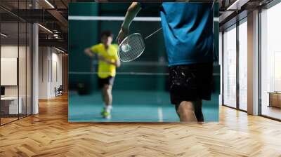 Asian badminton player is hitting in court Wall mural