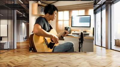 Asian man making music at home studio Wall mural