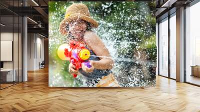 Asian woman are using water guns play in the Songkran festival Wall mural