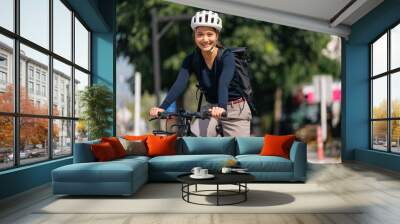 Asian woman bike to work In good weather Wall mural