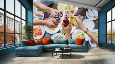 People are eating on vacation. They eat outside the house and clink beer house. Wall mural