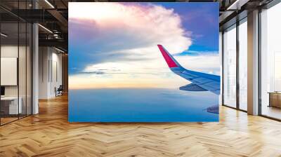 Sky and cloud view and wing of airplane Wall mural