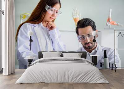  Attractive happiness scientist woman show her report to chief but he sleeping. Medical, pharmaceutical and scientific research and development concept. Wall mural