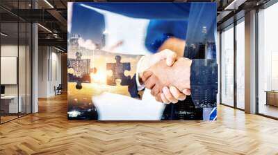 Business handshake after success deal with cooperation at meeting with Silhouette of Two men connect two puzzle pieces with sunset . Concept of business solution, solving a problem.	 Wall mural