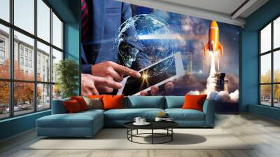 Businessman using digital tablet connect to global with space rocket taking off, night sky with milky way background Wall mural