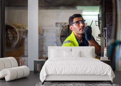 Caucasian engineer mechanic man checking for maintenance pressing metal machine by laptop at factory, worker at industrial concept	
 Wall mural