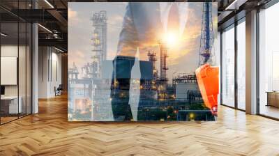 Double exposure of businessman or engineer hole orange helmet in hand with oil and gas refinery plant background Wall mural