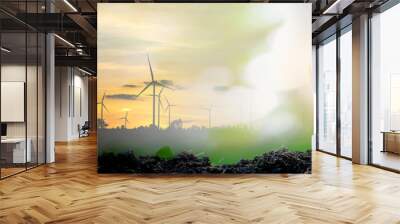 Silhouette of wind turbine and sapling growing in light bulb on natural soil, creative idea for green energy concept	 Wall mural