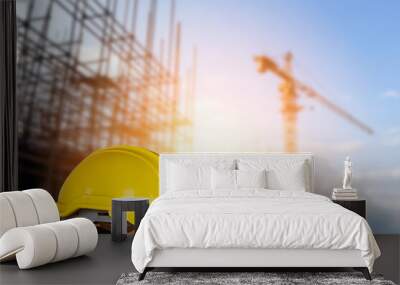 yellow helmet in construction site and construction site background safety first concept Wall mural