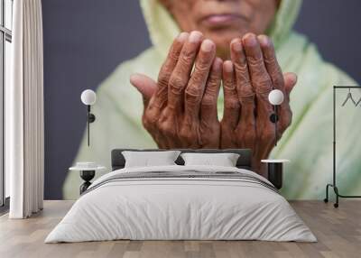 Close up of senior women hand praying at ramadan  Wall mural