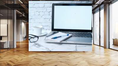 Laptop with white screen on office table Wall mural