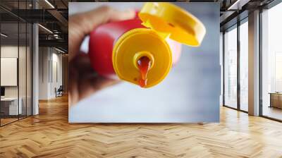 Pouring tasty ketchup from a bottle  Wall mural