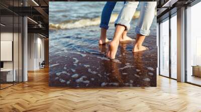 feet of couple woman and man in the sea waves Wall mural