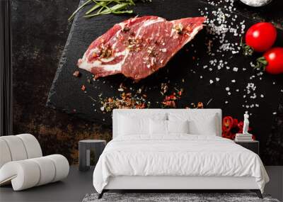 raw pork with spices for cooking on a fire or oven on a dark stone background Wall mural