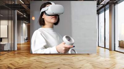 team of four creative engineers working with virtual reality, young woman testing VR glasses or goggles sitting in the office room Wall mural