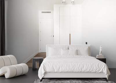 An empty modern bedroom with a built-in wardrobe with white doors and a built-in nail pull in wood color Wall mural