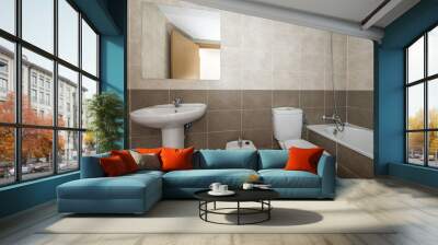 Bathroom without cabinets, with a long bathtub without screens, a square mirror on the wall and white toilets Wall mural