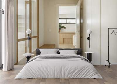 Corridor of a renovated apartment with smooth walls painted white, skylights and glass walls, a white work aramiro and an elongated oak plywood bench Wall mural