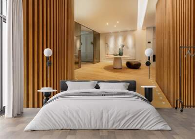 Hallway of a house with walls covered with latticework of vertical wooden slats, lamps on the light oak wood floor Wall mural