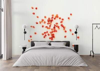 Loose pomegranate grains viewed from the top on a white surface Wall mural