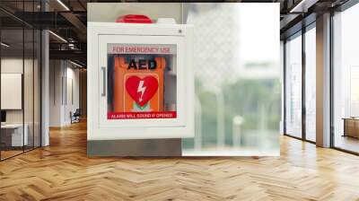 General view of a life saving defibrillator. Portable automated external defibrillator (AED) mounted on the wall in public restroom at airport. Wall mural