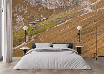 Some mountain haylofts in Dolomites with wonderful panorama at fall Wall mural