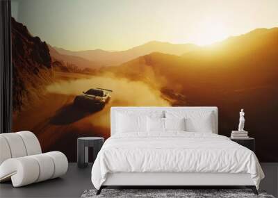 A sports car speeds down a dusty mountain road at sunset, creating a cloud of dust against the stunning backdrop of hills and glowing sky. Wall mural