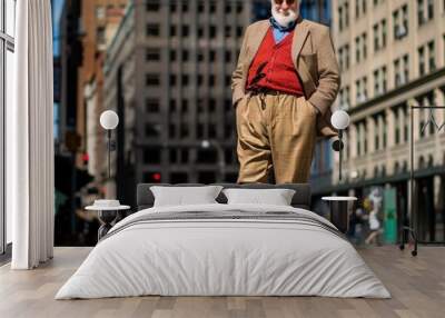 Stylish Elderly Man in Vintage Clothing Walking in Urban City Street on a Sunny Day Wall mural