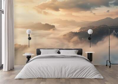 The misty panorama unveils a beautiful sunrise casting its glow upon the rocky mountains, offering a view of the foggy valley below. Wall mural