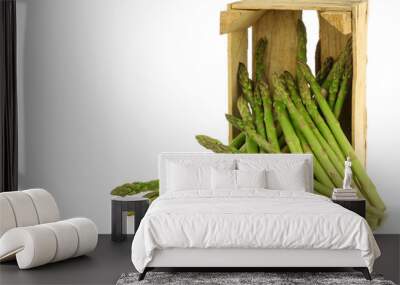  fresh green asparagus shoots in a wooden crate on a white backg Wall mural